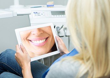 Woman looking at her virtual smile design images