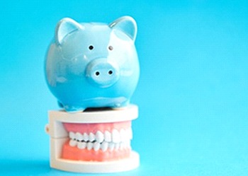 A blue piggy bank sitting on top of a mouth mold