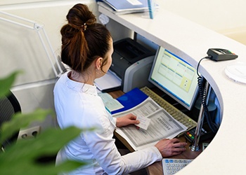 Woman sitting at front desk at dental office