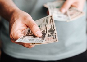 Man extending cash for payment