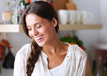 Woman with bright white smile after at home teeth whitening