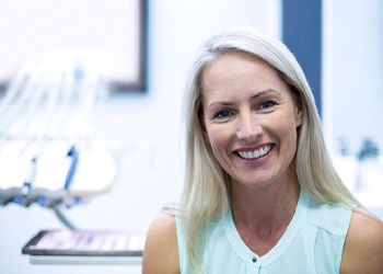 Woman in dental office smiling