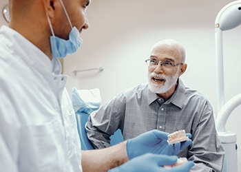 elderly man talking to his dentist