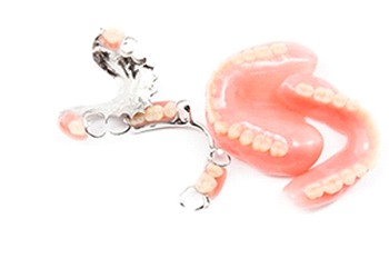 A set of full dentures and a set of partial dentures