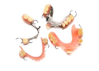 Various types of partial dentures created for patients with multiple missing teeth