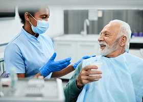 a patient asking his dentist about alternative tooth-replacement options