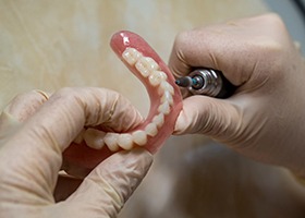 Lab technician crafting denture