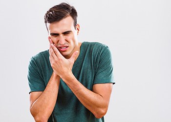 man with toothache who needs emergency dentist in Crown Point 