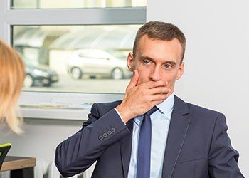 Businessman covering his mouth before dental emergency treatment