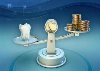 Tooth and coins on balance scale