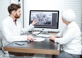 dentist showing a patient their dental X-rays