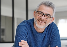 man smiling after getting dental implants in Crown Point 