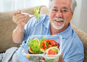 Man eating vegetables and salad in Crown Point