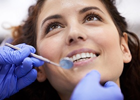 a person having their teeth examined by a dentist