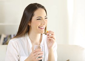 woman following dental implant post-op instructions in Crown Point