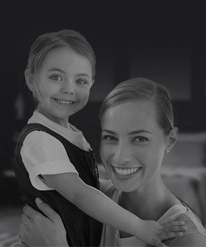 Smiling mother holding her young daughter