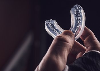 a person holding a mouthguard