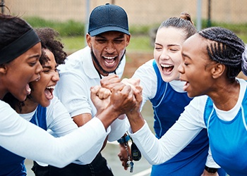 girls cheering with their coach