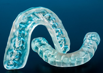 A closeup of clear plastic nightguards 