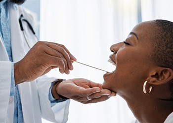 Patient opening wide for dentist during a routine exam