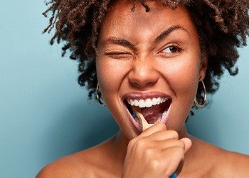 a woman brushing her teeth