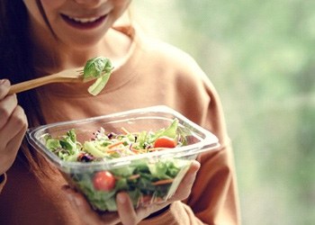 a person eating a salad