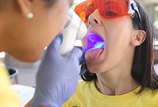 Woman receiving oral cancer screening