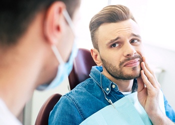 Pained man learning about root canal therapy in Crown Point