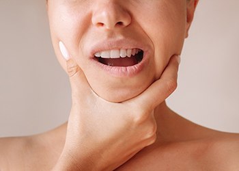 Woman holding her jaw