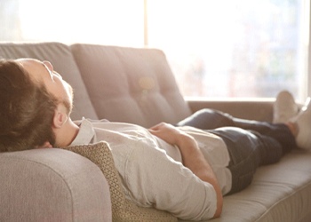 Man resting after receiving tooth extractions in Crown Point