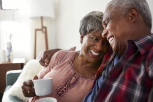 couple drinking coffee on their couch