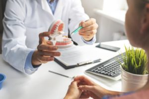 dentist speaking with patient about getting dental implants