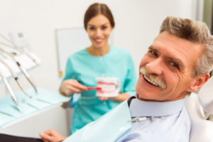 Elderly man smiling after getting dental implants in Crown Point