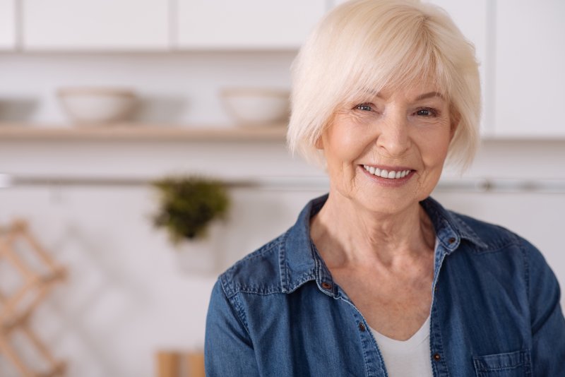 senior woman smiling with dental implants