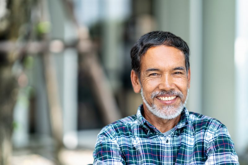 Man smiling with metal-free dental crown