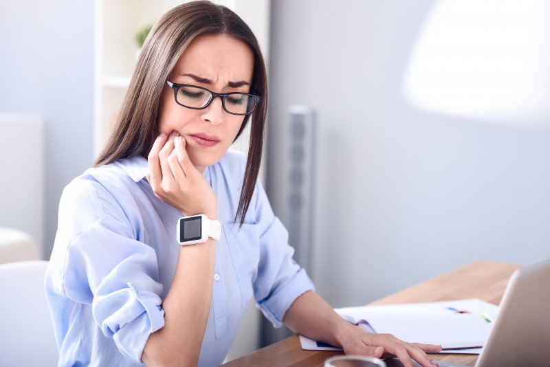 woman with toothache after a root canal in Crown Point