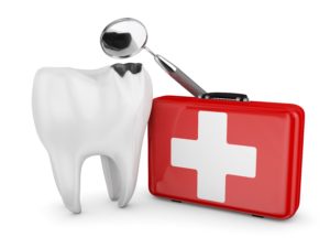 Large tooth next to a red medical kit with a white cross and a dental mirror