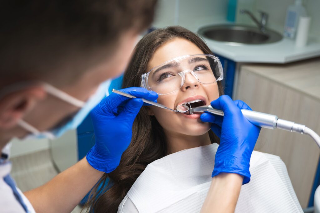 Woman undergoing root canal looking at dentist