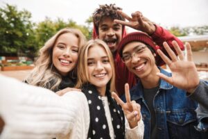 Teens smiling and taking a photo