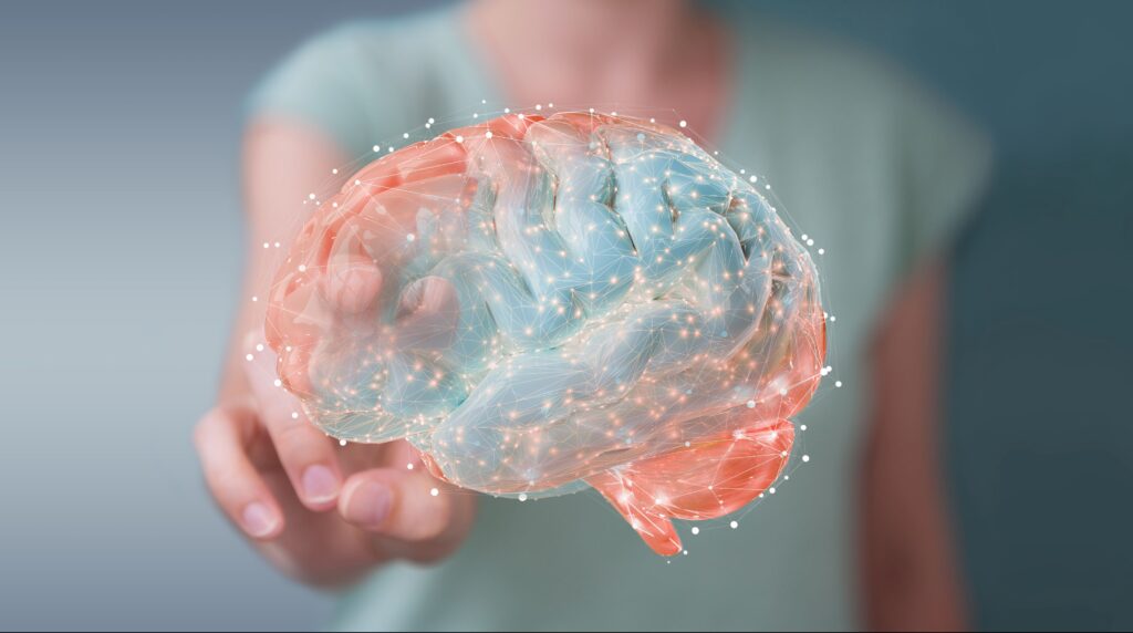 Woman reaching out with 2 fingers to touch colorful illustration of a brain